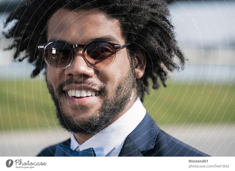 Portrait of smiling young man with sunglasses portrait portraits smile men males Adults grown-ups grownups adult people persons human being humans human beings