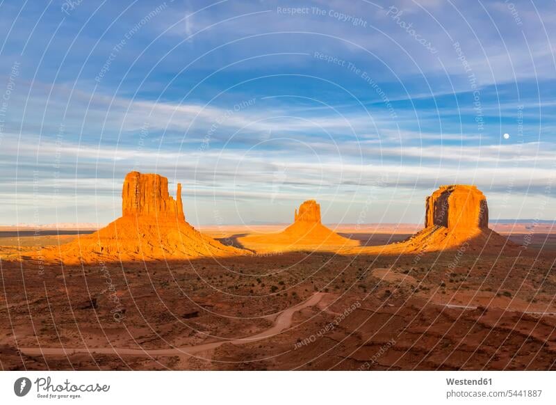 USA, Colorado Plateau, Utah, Arizona, Navajo Nation Reservation, Monument Valley, West Mitten Butte, East Mitten Butte and Merrick Butte in sunlight