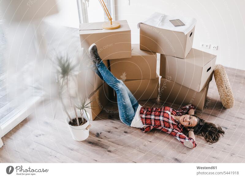Mature woman moving house, lying on floor, thinking ground land flat flats apartment apartments owner owners property move Moving Home floors females women