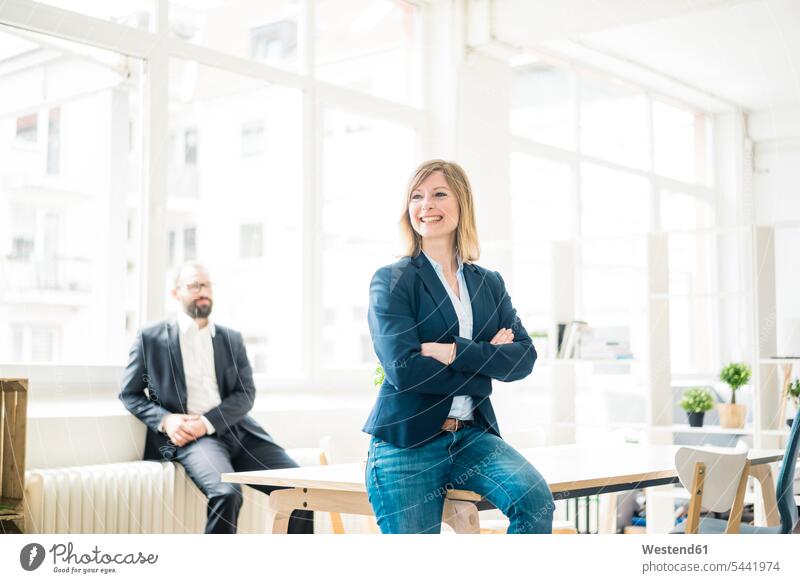 Smiling businesswoman and man in office businesswomen business woman business women Businessman Business man Businessmen Business men offices office room