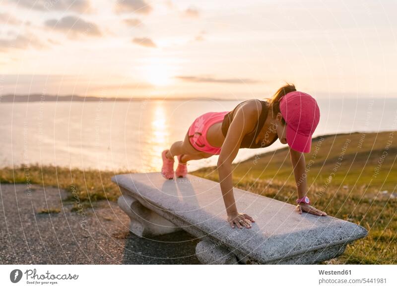Young woman doing strength training on a bench at the sea pushup Push-up Push-ups pushups press-up press-ups Push Up Push Ups females women fit exercising