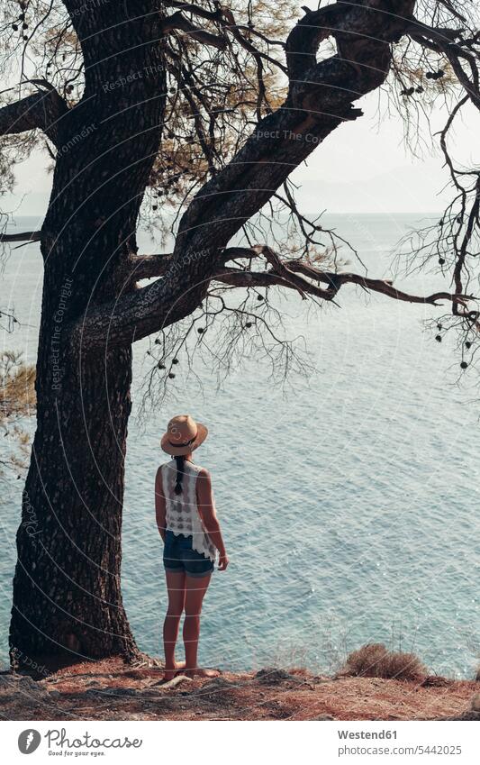 Greece, Chalkidiki, young woman looking at the sea ocean coast coastline coast area Seacoast seaside standing females women water waters body of water landscape