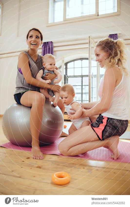 Mothers and babies in exercise room exercising training practising baby infants nurselings mother mommy mothers ma mummy mama smiling smile Fun having fun funny