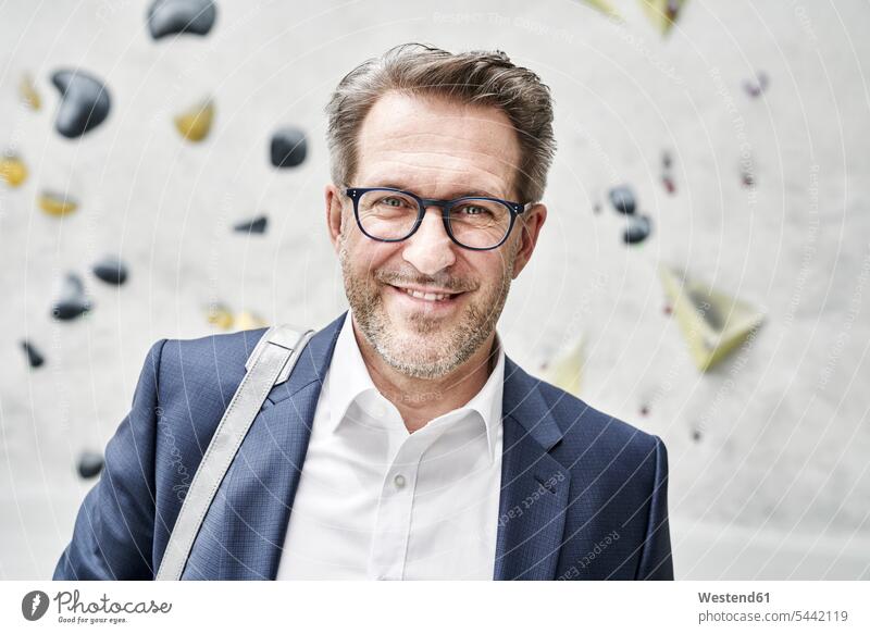 Portrait of smiling businessman with stubble wearing glasses Businessman Business man Businessmen Business men portrait portraits business people businesspeople