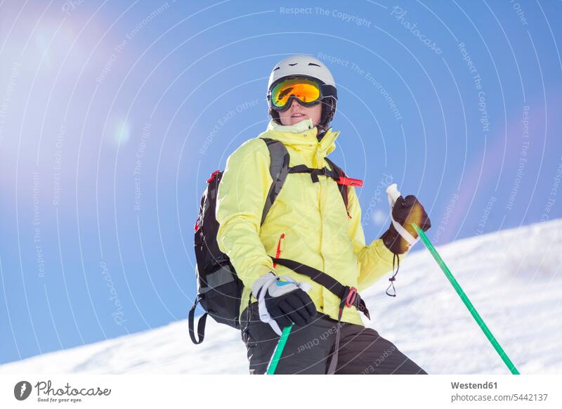 Austria, Bludenz, woman with ski helmet and avalanche backpack in the mountains females women mountain range mountain ranges Skiing Helmet Skiing Helmets