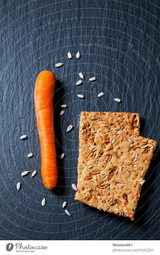 Two slices of crispbread with carrot and sunflower seed on slate food and drink Nutrition Alimentation Food and Drinks Pastry Pastries baked goods pastries
