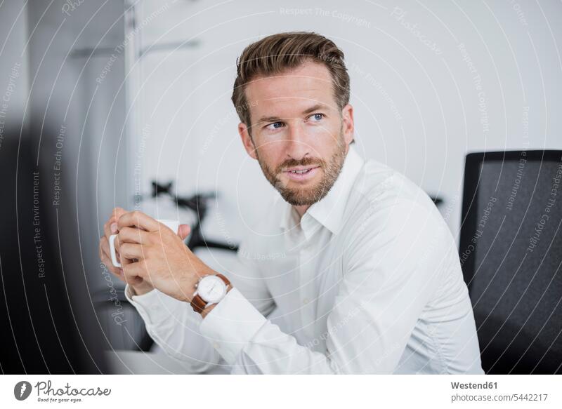 Portrait of businessman with coffee cup in the office Businessman Business man Businessmen Business men offices office room office rooms portrait portraits