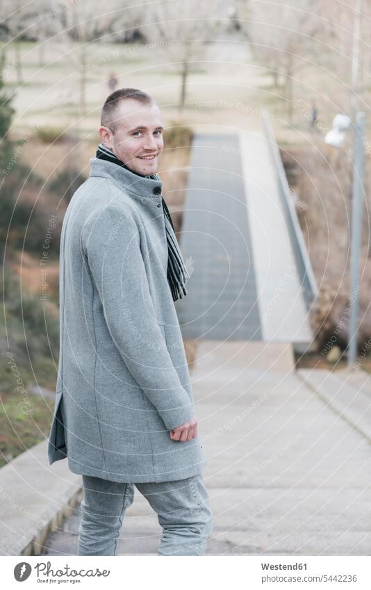 Portrait of smiling man on stairs in a park portrait portraits men males Adults grown-ups grownups adult people persons human being humans human beings parks