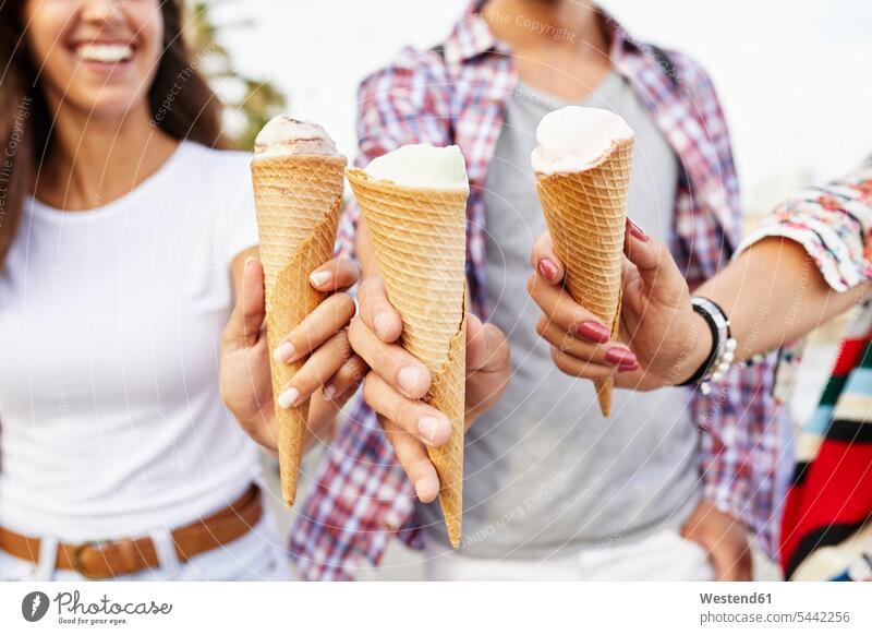 Close-up of three friends holding ice cream cones smiling smile hand human hand hands human hands mate people persons human being humans human beings Sweet Food
