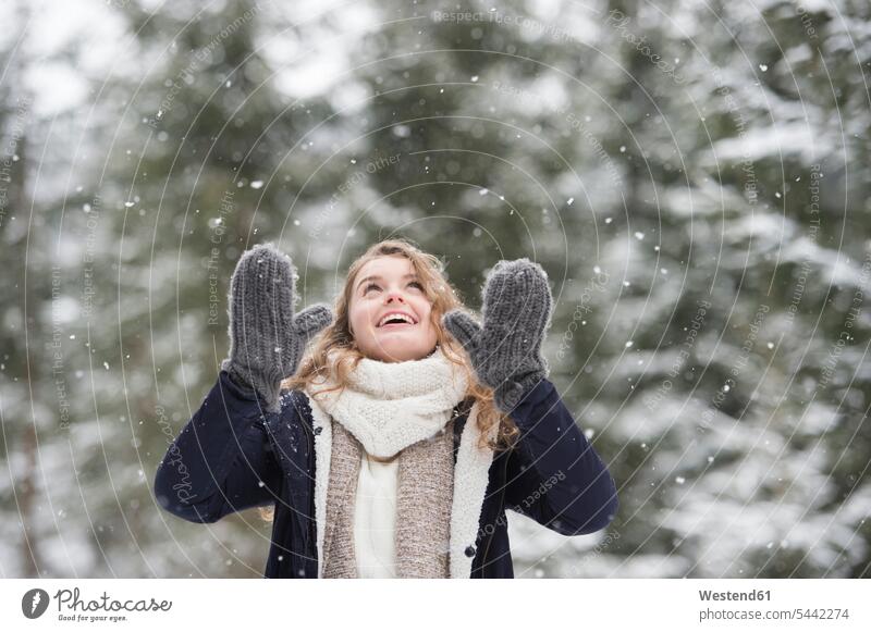 Portrait of happy young woman at snowfall in nature females women portrait portraits Adults grown-ups grownups adult people persons human being humans
