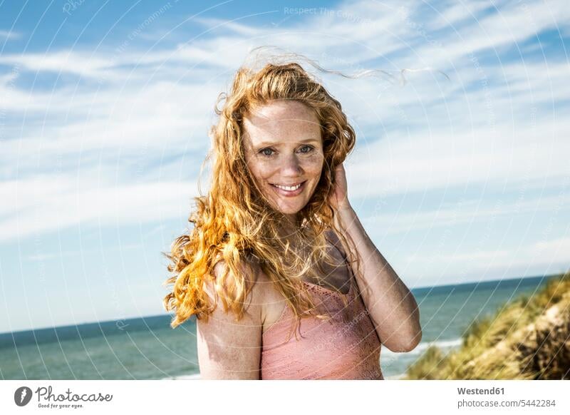 Netherlands, Zandvoort, portrait of smiling woman at the coast beach beaches portraits smile females women Adults grown-ups grownups adult people persons