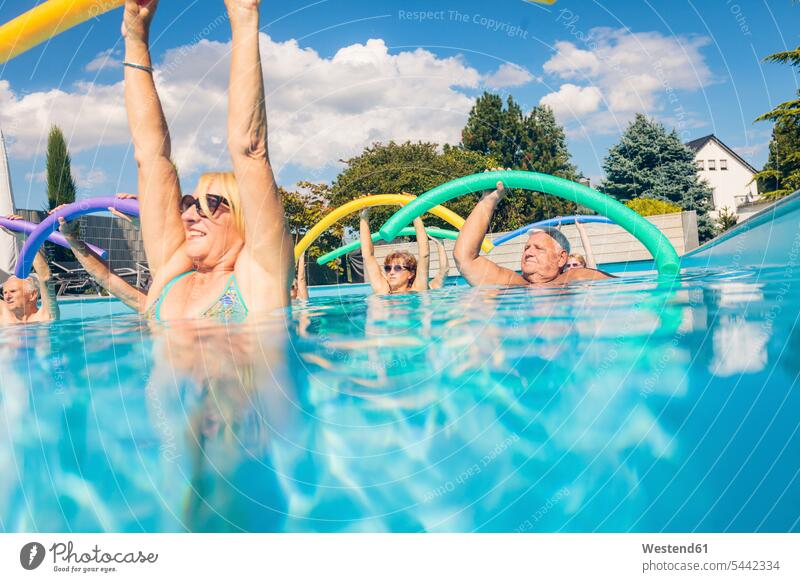 Group of seniors doing water gymnastics in pool group of people groups of people senior adults old swimming pool pools swimming pools exercise exercises