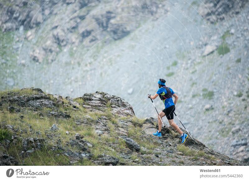 Italy, Alagna, trail runner on the move near Monte Rosa mountain massif mountains athlete Sportspeople Sportsman Sportsperson athletes Sportsmen males running