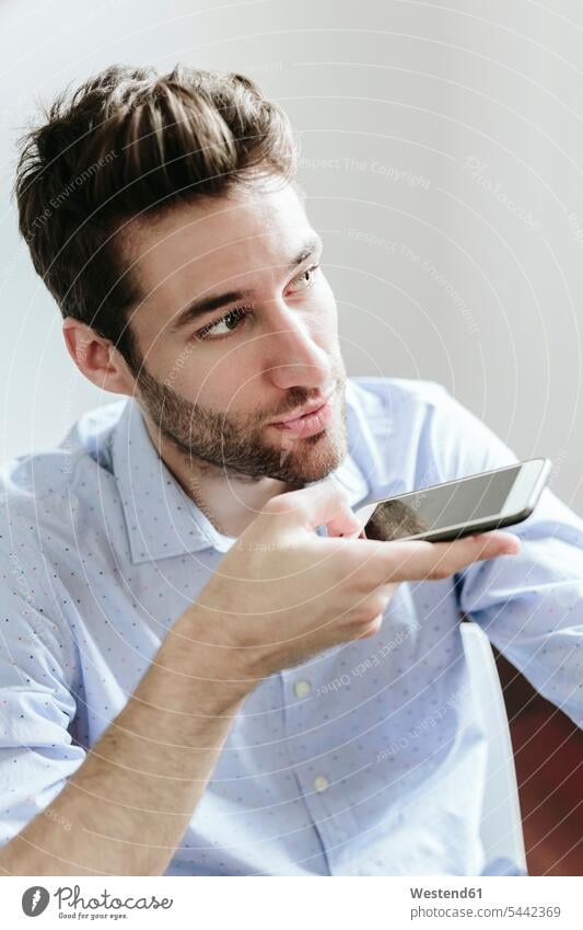 Young businessman working in office, using smartphone on the phone call telephoning On The Telephone calling Businessman Business man Businessmen Business men