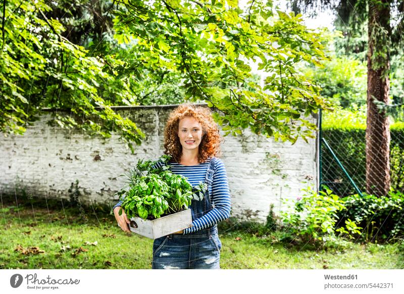 Portrait of young woman with fresh herbs in a box portrait portraits females women Adults grown-ups grownups adult people persons human being humans
