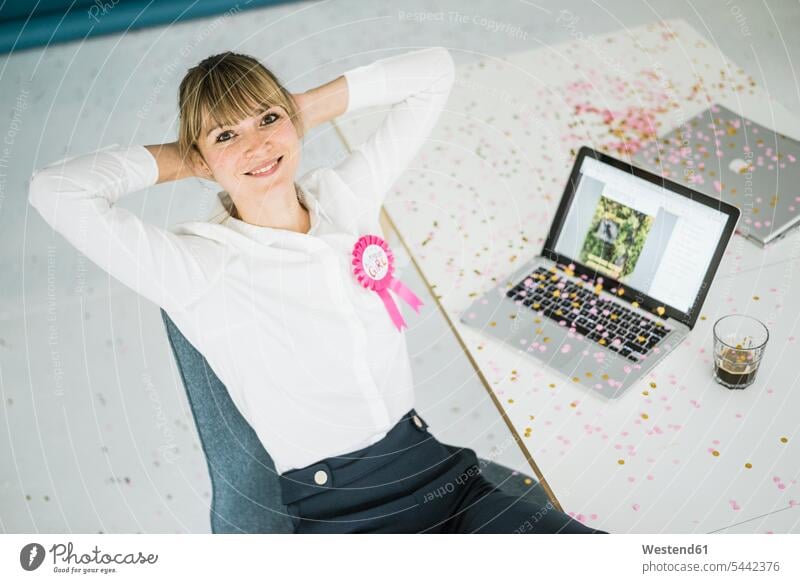 Portrait of smiling businesswoman with laptop in office celebrating her birthday smile offices office room office rooms Laptop Computers laptops notebook