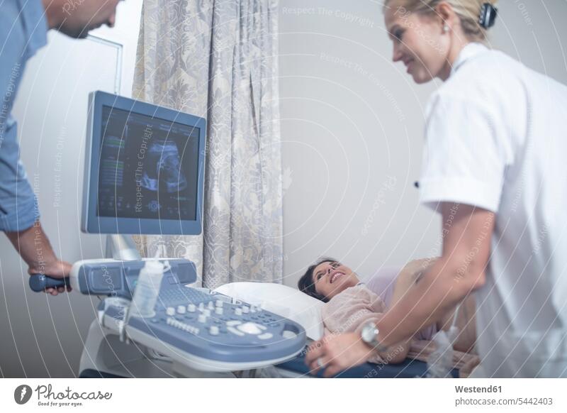 Doctor in hospital doing sonogram with pregnant woman Ultrasonography Female Doctor physicians Female Doctors examining checking examine Pregnant Woman