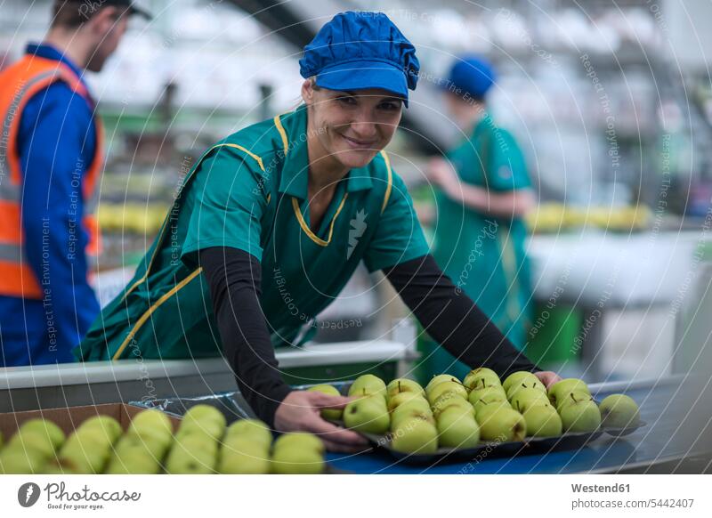Portrait of smiling woman working in apple factory Apple Apples At Work smile females women portrait portraits Fruit Fruits Food foods food and drink Nutrition