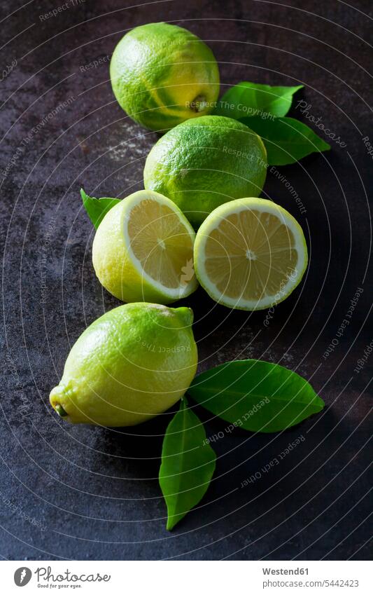 Green organic lemons on dark background overhead view from above top view Overhead Overhead Shot View From Above Lemon Lemons organic edibles Leaf Leaves green