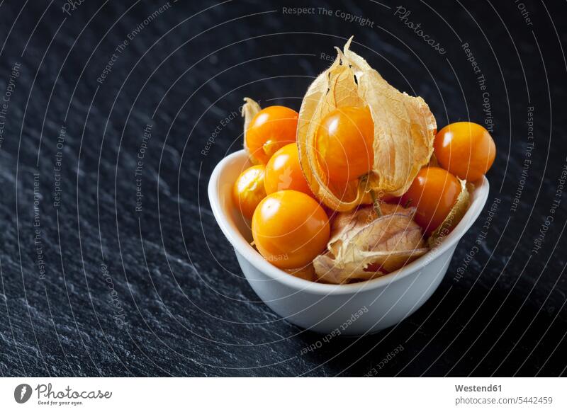 Bowl of Physalis on slate food and drink Nutrition Alimentation Food and Drinks overhead view from above top view Overhead Overhead Shot View From Above
