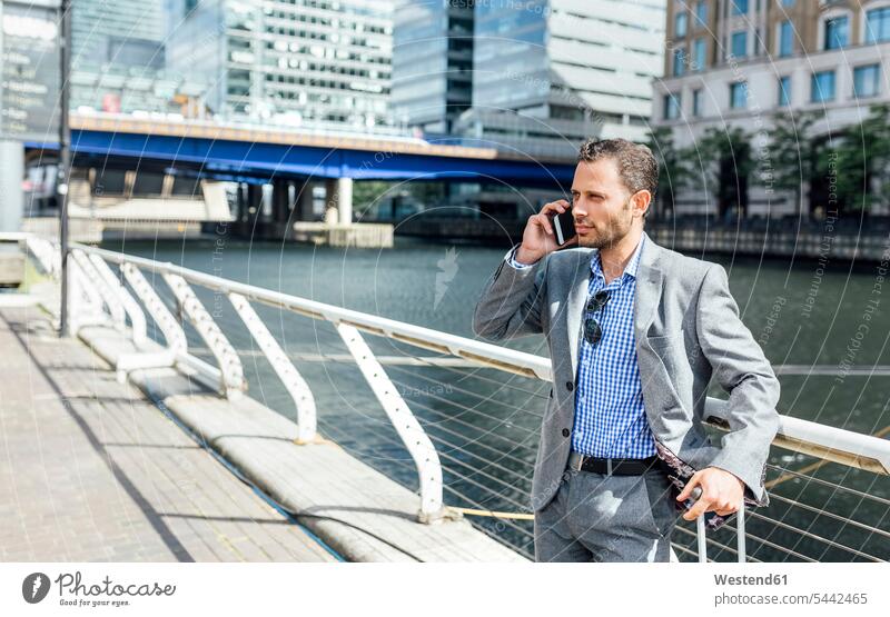 Businessman talking on the phone in the city call telephoning On The Telephone calling mobile phone mobiles mobile phones Cellphone cell phone cell phones