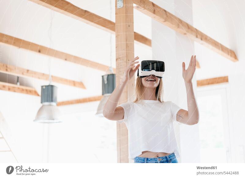 Young woman wearing VR goggles, designing her new home loft lofts Planning planning planned Virtual Reality Glasses VR glasses Virtual-Reality Glasses