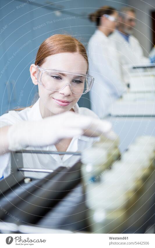 Smiling scientist in lab with samples swatch Swatches Samples smiling smile woman females women female scientists science sciences scientific laboratory Adults