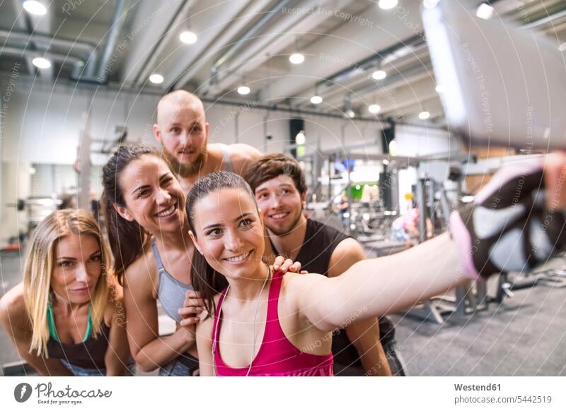 Young athletes having fun in the gym, taking selfies training Sport Training photographing fit gyms Health Club Selfie Selfies team friendship in good shape