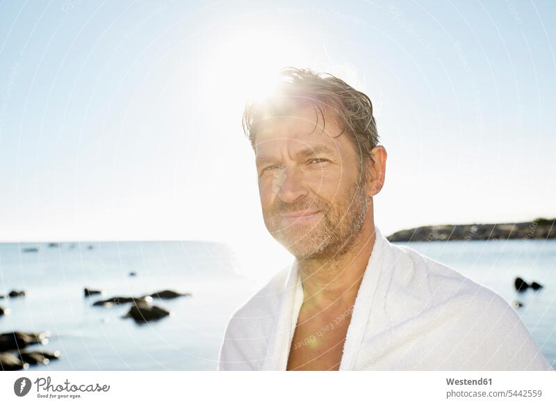 Portrait of smiling man with towel in front of the sea Sea ocean portrait portraits men males water Adults grown-ups grownups adult people persons human being