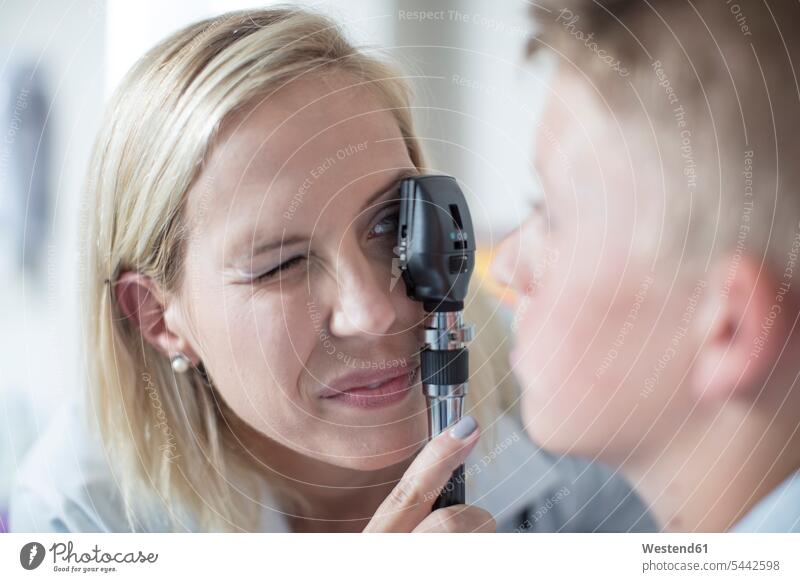 Female pedeatrician examining boy with an otoscope boys males pediatrician paediatricians healthcare and medicine medical Healthcare And Medicines child