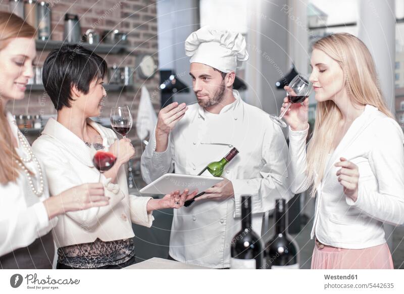 Chef with three women tasting red wine in kitchen Red Wine Red Wines chef cook cooks Chefs cooking course cooking class cooking lesson Alcohol