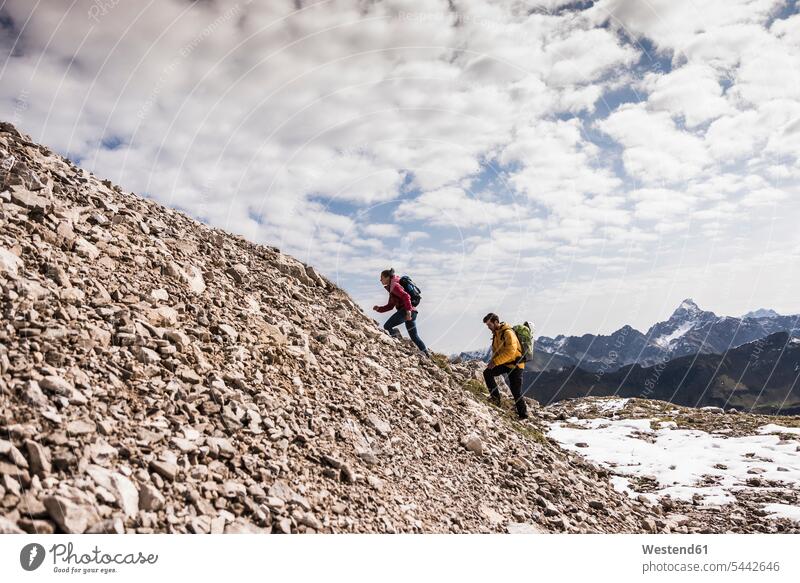 Germany, Bavaria, Oberstdorf, two hikers walking up stony mountain hiking going couple twosomes partnership couples mountain range mountains mountain ranges