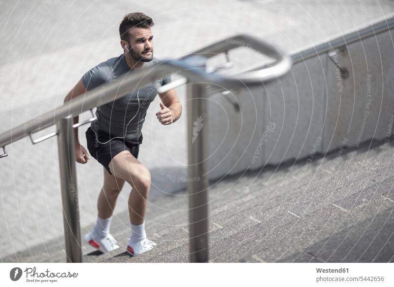 Athlete walking up stairs in the city exercising exercise training practising stairway man men males Adults grown-ups grownups adult people persons human being
