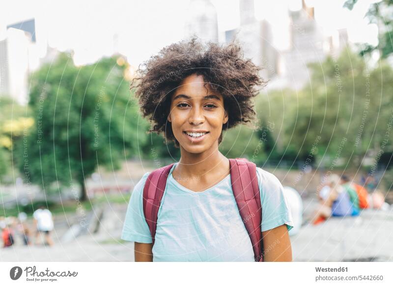 USA, Manhattan, portrait of smiling young woman in Central Park portraits females women Adults grown-ups grownups adult people persons human being humans