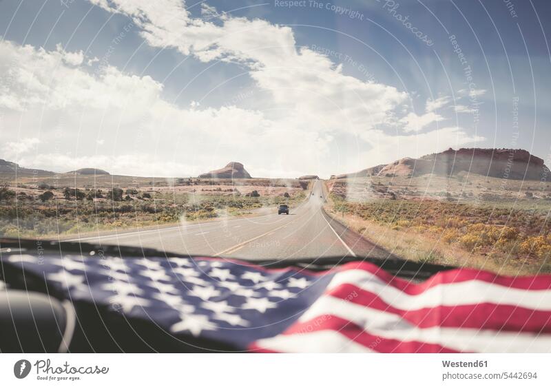 USA, Utah, American Flag lying on dashboard Stars And Stripes Star-Spangled Banner American Flags Flag of America windscreen car automobile Auto cars motorcars
