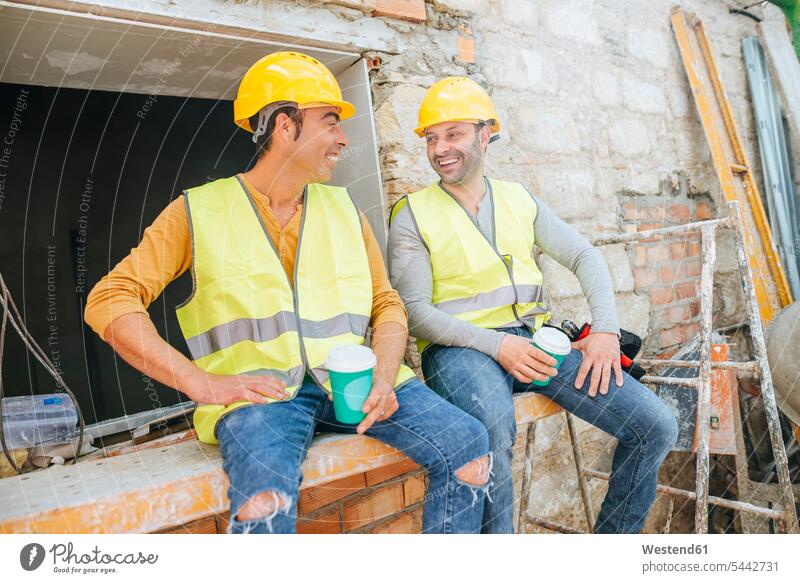Construction workers having a coffee break on construction site Coffee colleagues smiling smile Building Site sites Building Sites construction sites talking