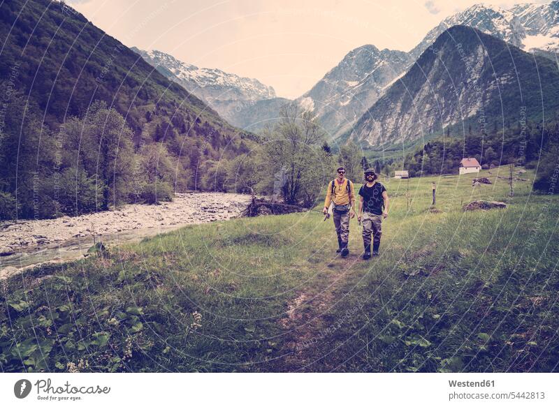 Slovenia, Bovec, two anglers walking on path towards Soca river man men males going hiking hike Adults grown-ups grownups adult people persons human being