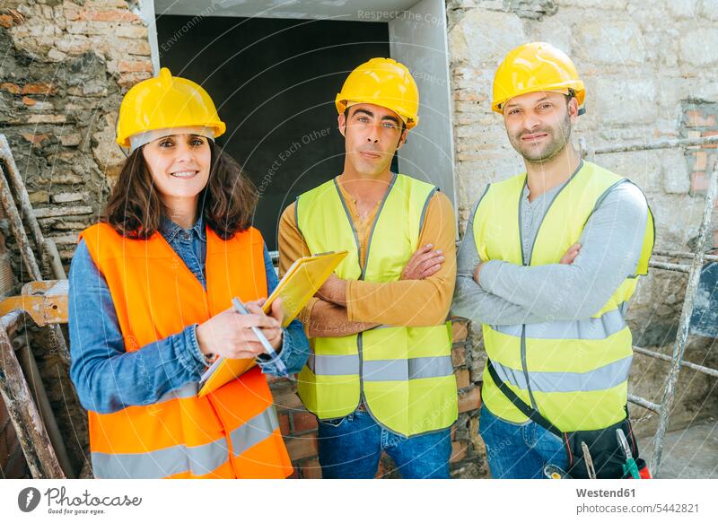 Woman with two construction workers on construction site colleagues Building Site sites Building Sites construction sites builders constructing craftsman trade