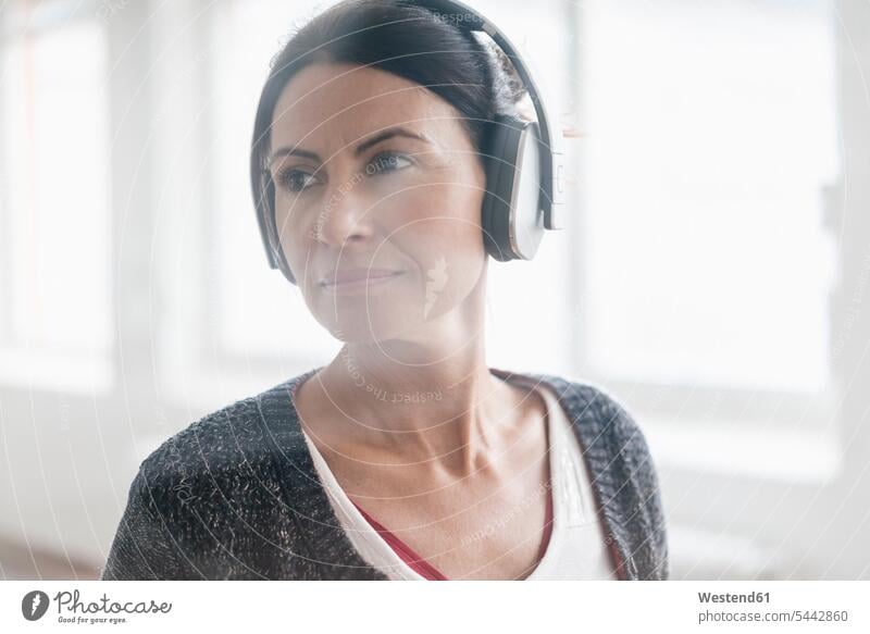 Portrait of woman listening music with headphones headset females women portrait portraits Adults grown-ups grownups adult people persons human being humans
