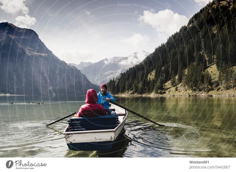 Austria, Tyrol, Alps, couple in rowing boat on mountain lake lakes twosomes partnership couples boats Oaring water waters body of water people persons