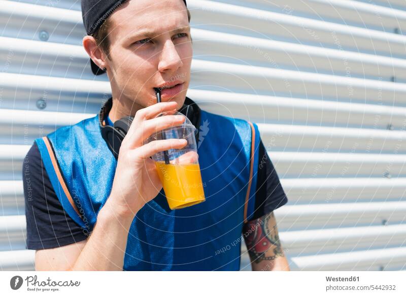 Tattooed young man with soft drink drinking men males portrait portraits Adults grown-ups grownups adult people persons human being humans human beings Drink
