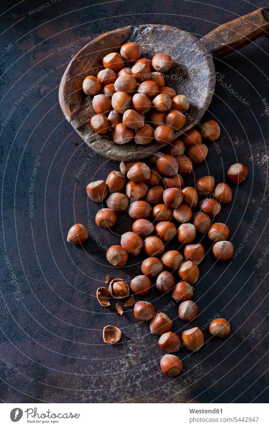 Whole and cracked hazelnuts on dark ground overhead view from above top view Overhead Overhead Shot View From Above whole Hazelnut Hazel-Nut Hazelnuts