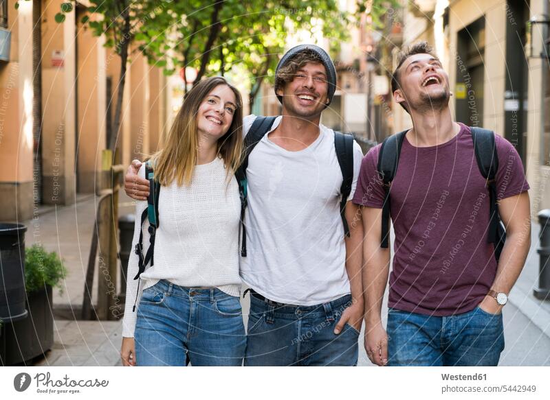 Happy friends walking in the city going laughing Laughter happiness happy friendship positive Emotion Feeling Feelings Sentiments Emotions emotional town cities