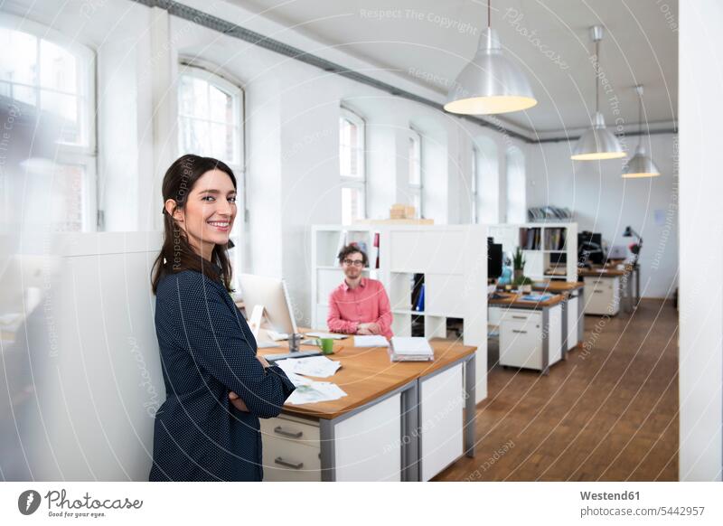 Portrait of smiling woman and man in office offices office room office rooms workplace work place place of work smile colleagues business business world