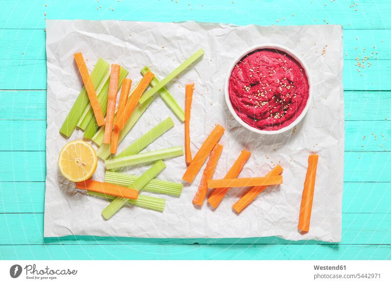 Bowl of beetroot hummus, sesame, and carrot and celery crudites Starter Starters Appetizer Appetizers mashed puréed Beetroot Hummus paper chickpeas cream