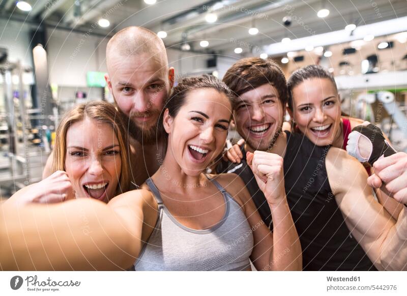 Young athletes having fun in the gym, taking selfies gyms Health Club team fit friendship training Sport Training in good shape Selfie Selfies photographing