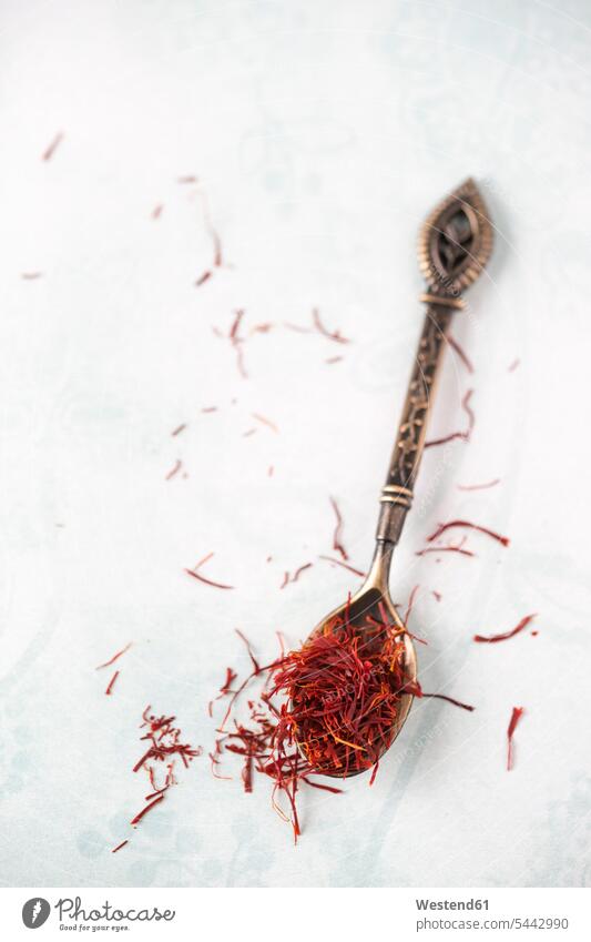 Spoon with saffron threads on light ground food and drink Nutrition Alimentation Food and Drinks copy space spice flavouring flavoring spices saffron stigmas