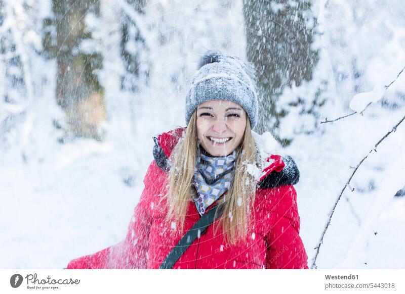 Portrait of smiling young woman in heavy snowfall portrait portraits females women Adults grown-ups grownups adult people persons human being humans