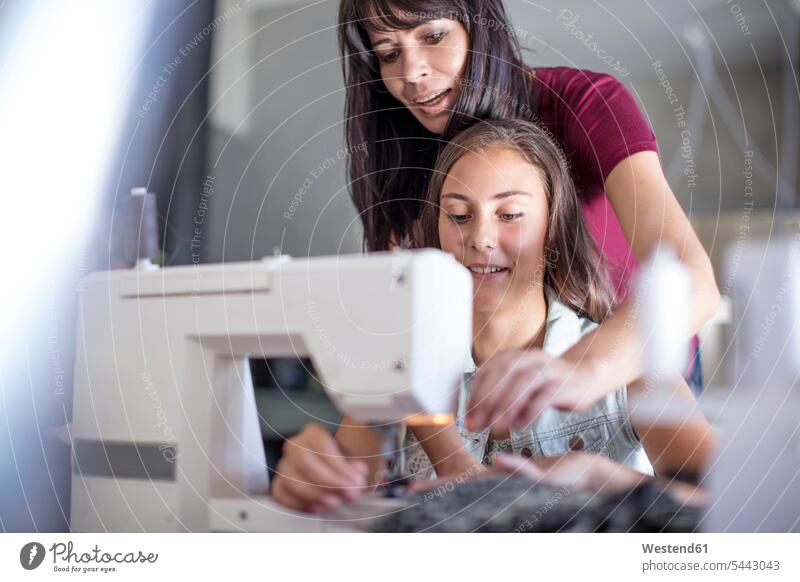 Mother and daughter sewing together daughters mother mommy mothers ma mummy mama sewing machine sewing machines learning child children family families people