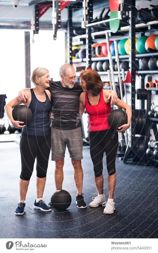 Group of fit seniors with medicine balls in gym gyms Health Club exercising exercise training practising friends smiling smile senior adults old fitness sport